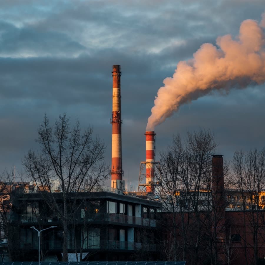 Steel plant stacks releasing emissions at dusk